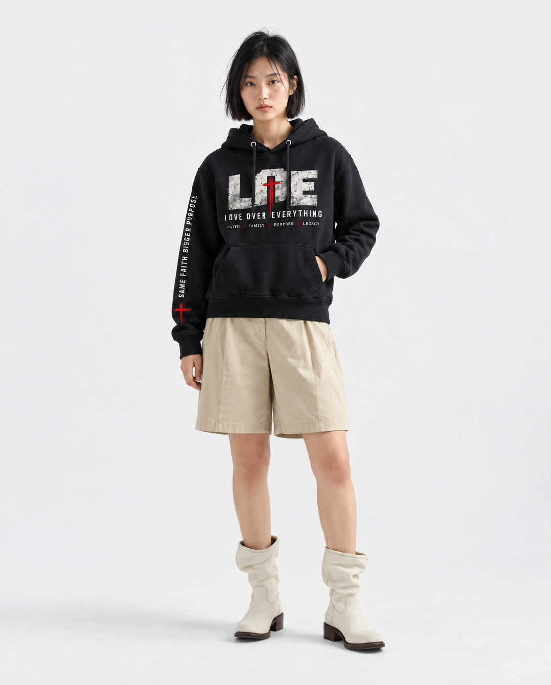 Model wearing the black Love Over Everything hoodie