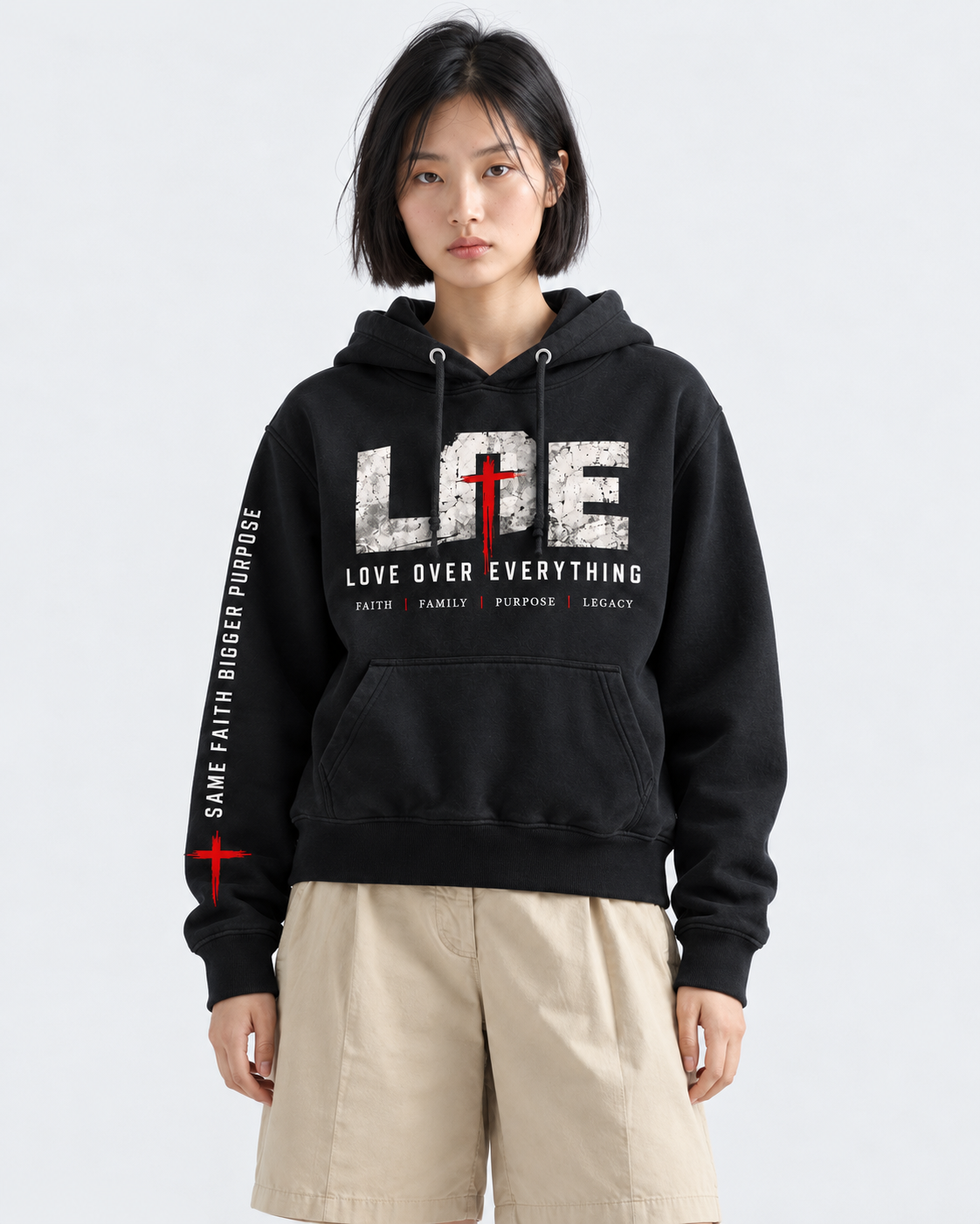 Model wearing the black Love Over Everything hoodie