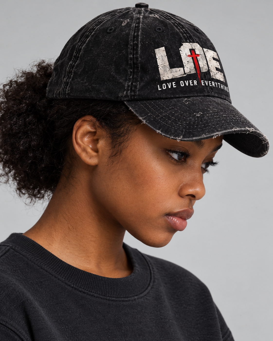 Model wearing the black Love Over Everything cap